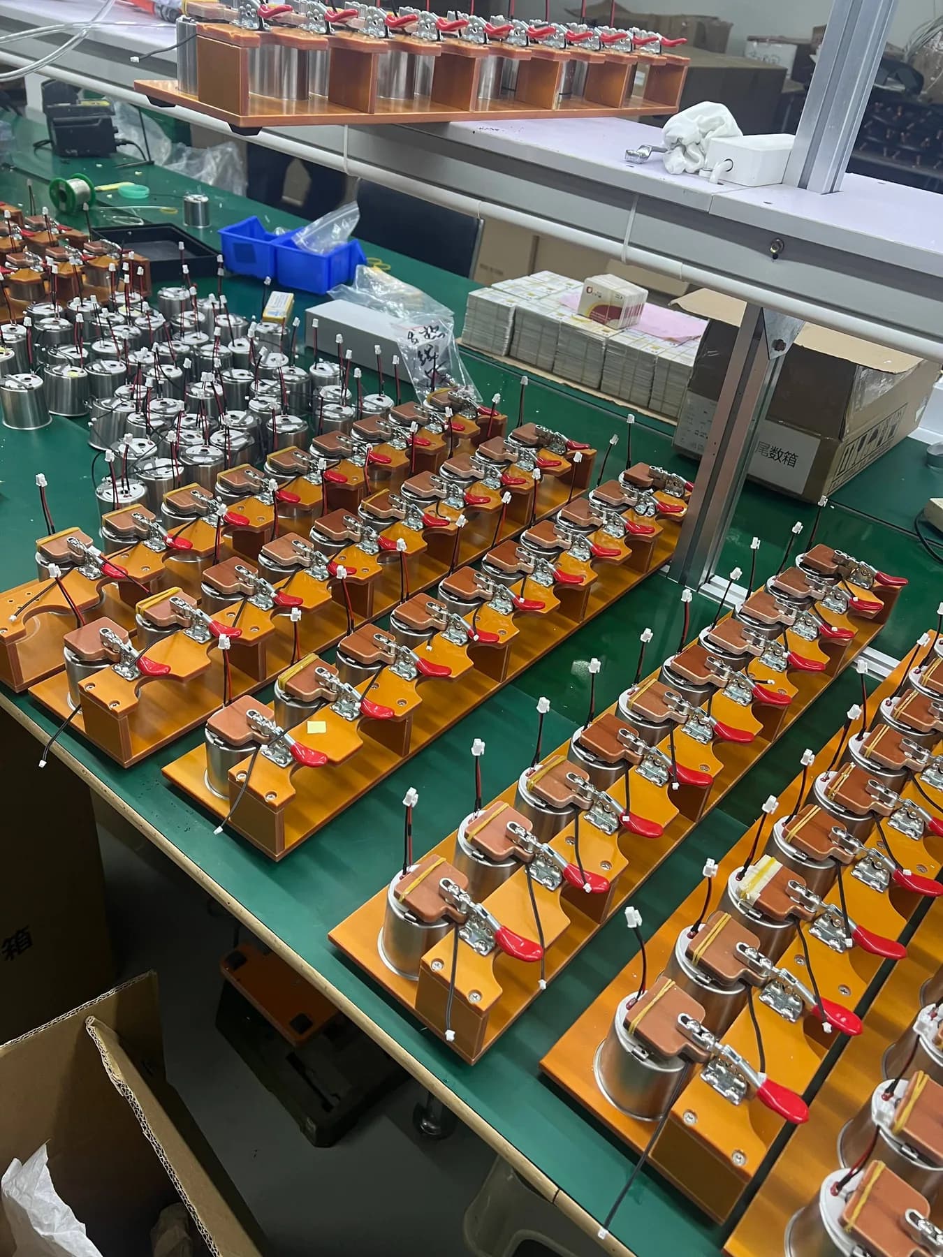 Multiple portable coffee machine heating modules secured in test fixtures